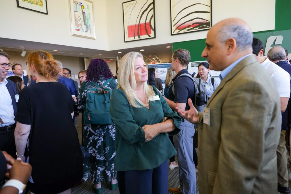 Christine Richardson and Amed Helmy  engage in conversation at the 2026 Biomedical Sciences Symposium.