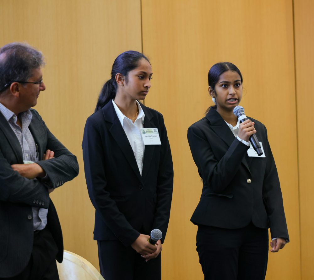 Twin sisters, Aathmika and Avanthika Thanigai, share details about their poster. Photo by Kat Lawrence.